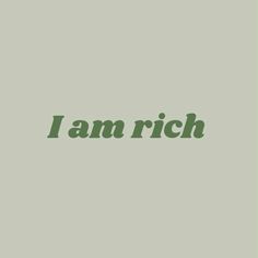 the word i am rich written in green on a gray background