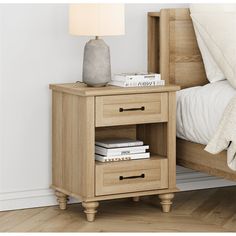 a night stand with two drawers and a lamp next to it on top of a bed