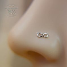 a close up view of a nose with an infinite sign on it