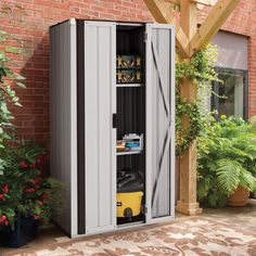 an outdoor storage shed with its doors open