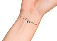 a woman's wrist with a small tattoo on it that says, i love you