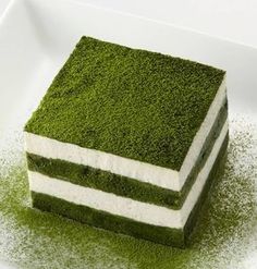 a piece of green cake sitting on top of a white plate