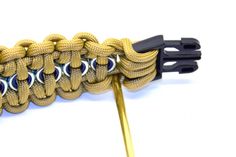 an image of a cord that has been wrapped in gold and black thread with eyeballs on it