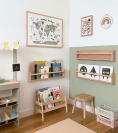 a child's room with bookshelves, toys and pictures on the wall