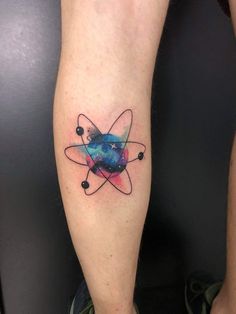 a person with a tattoo on their leg that has an image of the planet and stars