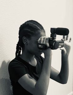 a woman holding a camera up to her face