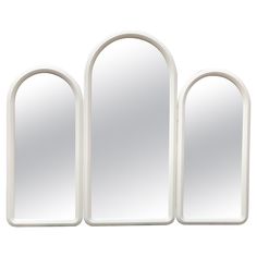 three white arched mirrors are shown against a white background and one is in the shape of an arch