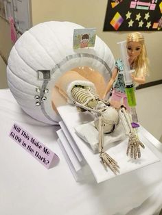 there is a doll and skeleton on the table