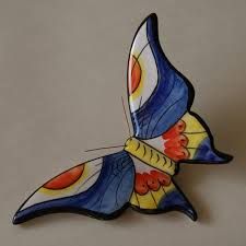 a blue and yellow butterfly sitting on top of a table