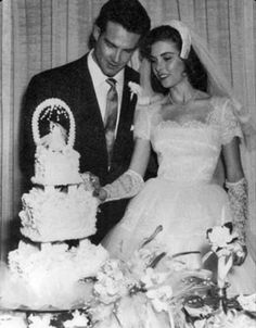 a bride and groom cutting their wedding cake