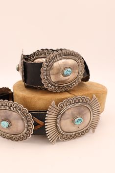 Add a unique twist to your look with this stunning leather belt that features 11 sterling silver conchos with turquoise dots in the center. Customize the fit to your body and enjoy the perfect western look that is sure to turn heads! Material: Leather, Sterling Silver, Turquoise Size: One size. Vendor: Nancy Rose Luxury Western Jewelry With Polished Finish, Western Conch Belts, Luxury Lariat Concho Jewelry, Luxury Concho Belts For Western-themed Events, Luxury Bohemian Concho Cuff Bracelet, Cowgirl Concho Belt, Luxury Bohemian Concho Belt, Red Turquoise Honcho Belt, Luxury Western Concho Cuff Bracelet