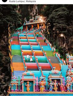 colorfully painted steps leading up to the top of a hill in india with lights on them