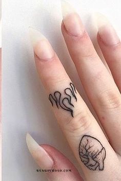 a woman's hand with two tattoos on it