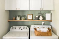 a white washer and dryer sitting next to each other in a laundry room