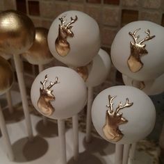 some cake pops with gold deer heads on them