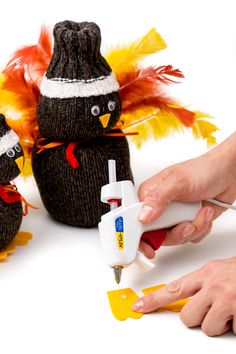 two stuffed birds are being used to decorate the holiday decorations with scissors and glue on them