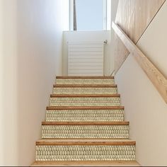 the stairs are made of wood and woven carpet