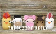 four farm animals are lined up next to each other on a wooden surface with the words fuzzyfrity