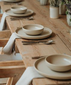 the table is set with plates and silverware