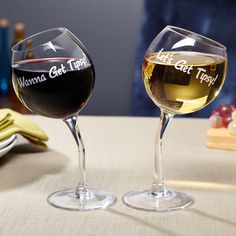 two wine glasses sitting next to each other on a table