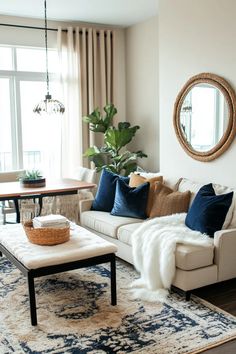 a living room filled with furniture and a large mirror on the wall above it's windows