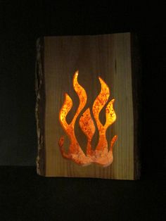 a piece of wood that has some kind of fire on it with flames in the middle