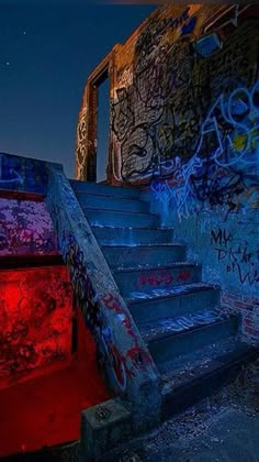 the stairs are covered in graffiti and red light