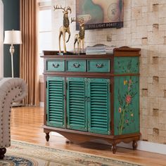 a green cabinet with wooden shutters in a living room