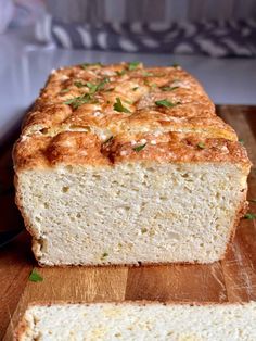 a loaf of bread sitting on top of a wooden cutting board