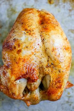 a close up of a chicken on a pan