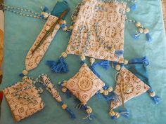 several pieces of cloth with tassels and beads on them sitting on a table