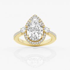 a yellow gold engagement ring with an oval cut diamond surrounded by small round brilliant diamonds