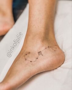 a woman's foot with the zodiac sign virgo on her left side and stars in the middle