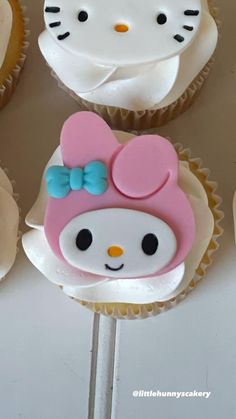 hello kitty cupcakes with pink and blue decorations