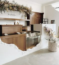 a kitchen that has been torn apart by the wall and is decorated with greenery