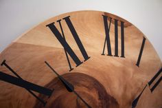 a wooden clock with roman numerals on it