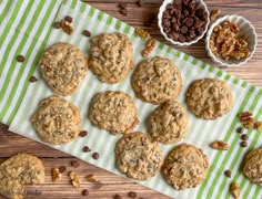 chocolate chip cookies with pecans and walnuts next to them on a green striped napkin