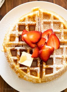 a waffle topped with strawberries and butter on a white plate