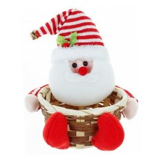 a santa clause stuffed animal sitting in a basket with red and white stripes on it