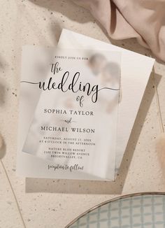 the wedding stationery is laid out on a table next to a plate and napkin