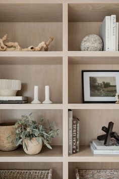 the shelves are filled with books and vases