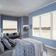 a bedroom with blue walls and white windows