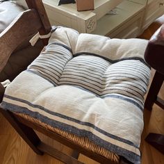 a wooden chair with a striped cushion on it