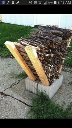 a pile of wood sitting on top of a cement block