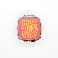 a compact mirror with the words good vibes only on it in yellow and red