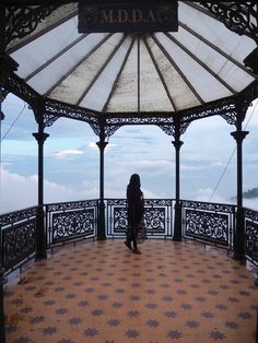 a woman standing on top of a gazebo