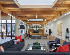 a living room filled with lots of furniture next to a fire place in a building