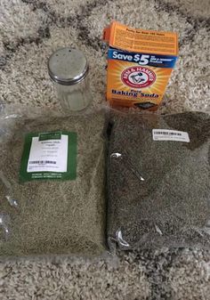 two bags of rice sitting on top of a carpet next to a bag of flour