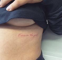 a woman's stomach with a tattoo that says, focus on the good written in red ink