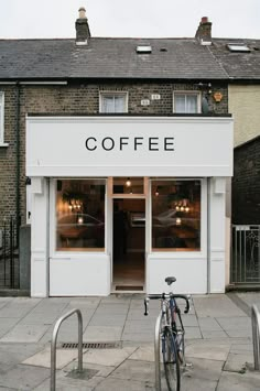 a bicycle parked in front of a coffee shop